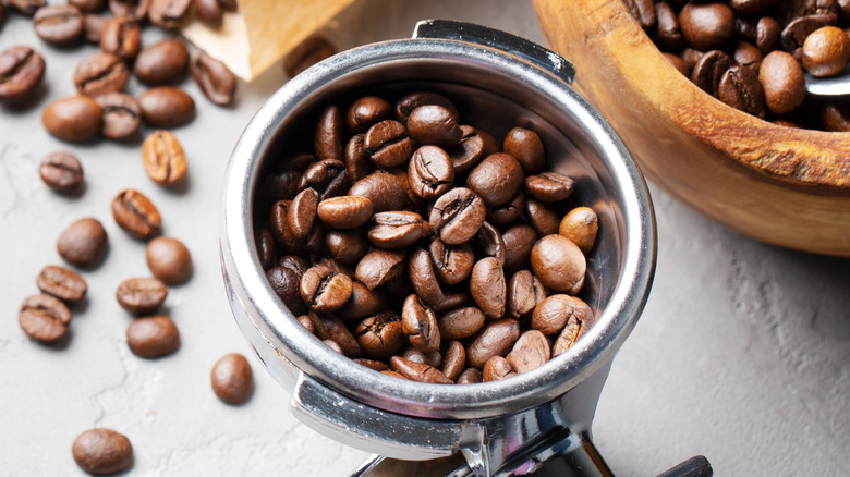 Coffee,Beans,In,A,Wooden,Bowl,Made,Of,Olive,Wood,